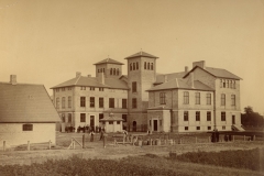 1881 Det kgl. Døvstumme-Institut i Fredericia fotograferet i 1881. Håndværkerne er i gang med at færdiggøre gårdspladsen, så der er klar til det store rykind af elever i september